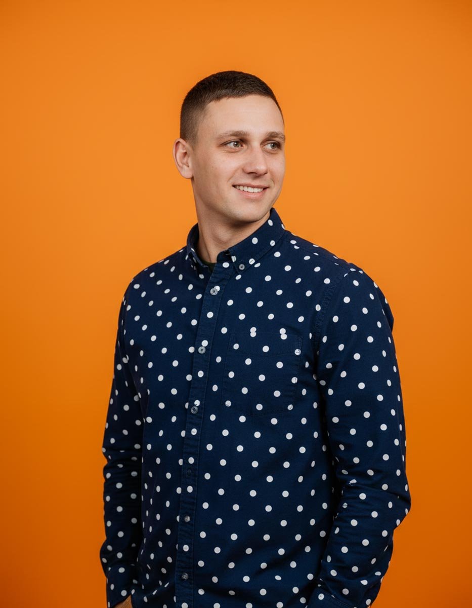 AI lifestyle portrait — man in polka dot shirt, orange backdrop